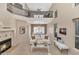 Bright living room boasts a fireplace, soaring ceilings, and an open concept layout to the dining room at 9452 S 51St St, Phoenix, AZ 85044