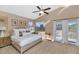 Spacious main bedroom with king-size bed, large windows, and access to balcony at 9452 S 51St St, Phoenix, AZ 85044