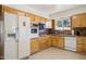 Bright kitchen with wood cabinets, tile floor, and modern appliances at 10288 W Snead N Cir, Sun City, AZ 85351