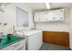 Laundry room with washer, dryer and shelving at 10288 W Snead N Cir, Sun City, AZ 85351