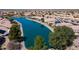 Aerial view of a tranquil lakefront property with mature trees at 10642 W Mohawk Ln, Peoria, AZ 85382