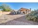 Covered patio, storage shed, and gravel backyard with desert landscaping at 10642 W Mohawk Ln, Peoria, AZ 85382