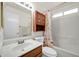 Guest bathroom with a shower/tub combo, pedestal sink and linen cabinet at 10642 W Mohawk Ln, Peoria, AZ 85382