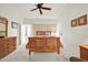 Bright bedroom with carpeted floor and wooden bed frame at 10642 W Mohawk Ln, Peoria, AZ 85382