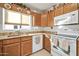 Well-equipped kitchen with wooden cabinets and white appliances at 10642 W Mohawk Ln, Peoria, AZ 85382