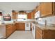 Well-equipped kitchen featuring granite countertops and ample wood cabinets at 10642 W Mohawk Ln, Peoria, AZ 85382