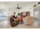 Living room with tiled floors, comfortable seating and view of patio at 10642 W Mohawk Ln, Peoria, AZ 85382