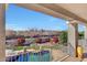 Elevated view of backyard oasis with sparkling pool, lush landscaping, and mountain backdrop at 11224 N 152Nd Ln, Surprise, AZ 85379