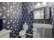 Modern bathroom with geometric wallpaper, updated vanity, and a toilet at 11224 N 152Nd Ln, Surprise, AZ 85379