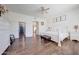 Bright bedroom with wood-look floors, white furniture, and access to the hallway at 11224 N 152Nd Ln, Surprise, AZ 85379