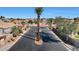 Gated community entrance with palm trees and paved road at 11224 N 152Nd Ln, Surprise, AZ 85379