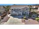 Two-story house with gray exterior, two-car garage and landscaping at 11224 N 152Nd Ln, Surprise, AZ 85379