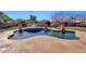 Inviting kidney-shaped pool with a surrounding patio and lush landscaping at 11224 N 152Nd Ln, Surprise, AZ 85379