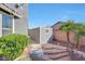 Gray storage shed in backyard with gravel pathway and landscaping at 11224 N 152Nd Ln, Surprise, AZ 85379