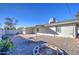 Backyard with gravel, fire pit, and covered patio at 11451 E Broadway Rd, Mesa, AZ 85208