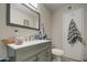 Modern bathroom with gray vanity and a large mirror at 11451 E Broadway Rd, Mesa, AZ 85208