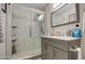 Clean bathroom with a walk-in shower and modern vanity at 11451 E Broadway Rd, Mesa, AZ 85208