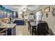 Kitchen with granite countertops, dark blue cabinets, and a dining area at 11451 E Broadway Rd, Mesa, AZ 85208