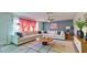 Bright living room featuring a large sectional sofa, modern rug, and stylish decor at 11451 E Broadway Rd, Mesa, AZ 85208