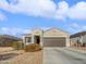 Single-story home with a two-car garage and desert landscaping at 11468 E Sunflower Ln, Florence, AZ 85132