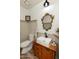 Elegant powder room with antique vanity and ornate mirror at 11935 N 148Th Ave, Surprise, AZ 85379