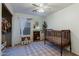 bedroom with crib, shelving, and closet at 11935 N 148Th Ave, Surprise, AZ 85379