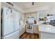 Kitchen with white cabinets, gas range, and view to living area at 11935 N 148Th Ave, Surprise, AZ 85379