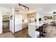 Kitchen with island, white cabinets, and view to living area at 11935 N 148Th Ave, Surprise, AZ 85379