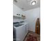 Bright laundry room with washer, dryer, and extra shelving at 11935 N 148Th Ave, Surprise, AZ 85379