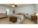 Main bedroom features a king bed, ensuite bathroom, and a ceiling fan at 11935 N 148Th Ave, Surprise, AZ 85379