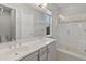 Modern bathroom with double vanity, large mirror, and glass shower at 12007 W Creosote Dr, Peoria, AZ 85383