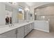 Elegant bathroom with double vanity, large mirror, and a walk-in shower at 12007 W Creosote Dr, Peoria, AZ 85383