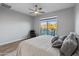 Bright bedroom with large window, ceiling fan and comfortable bed at 12007 W Creosote Dr, Peoria, AZ 85383