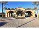 Gated community entrance with arched entryway and landscaping at 12007 W Creosote Dr, Peoria, AZ 85383