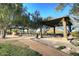 Covered picnic area with tables and benches under a pergola at 12007 W Creosote Dr, Peoria, AZ 85383