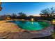 Inviting backyard pool with a waterfall and fire pit at 12007 W Creosote Dr, Peoria, AZ 85383