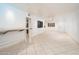 Living room with tile floor, white walls and kitchen access at 12212 N Paradise Village S Pkwy # 134, Phoenix, AZ 85032