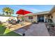 Flagstone patio with seating area, fire pit, and colorful mural at 12526 W Paintbrush Dr, Sun City West, AZ 85375