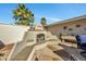 Outdoor fireplace with built-in seating and stonework at 12526 W Paintbrush Dr, Sun City West, AZ 85375