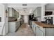 Modern kitchen with light green cabinets and butcher block counter at 12526 W Paintbrush Dr, Sun City West, AZ 85375