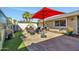 Outdoor patio with seating area, fire pit, and red umbrella at 12526 W Paintbrush Dr, Sun City West, AZ 85375