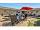 Relaxing patio with flagstone flooring, seating area, and red umbrella at 12526 W Paintbrush Dr, Sun City West, AZ 85375