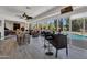 Sunroom with pool view, table and chairs, and a wet bar at 12526 W Paintbrush Dr, Sun City West, AZ 85375