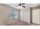 Bright bedroom with ceiling fan and double door closet at 12618 W Catalina Dr, Avondale, AZ 85392