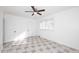 Well-lit bedroom featuring tile floors, ceiling fan, and closet at 1312 E Coolidge St, Phoenix, AZ 85014