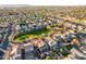 Aerial view of a two story house with solar panels, near a park at 13627 N 150Th Ave, Surprise, AZ 85379