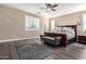 Main bedroom with dark wood furniture and ceiling fan at 13627 N 150Th Ave, Surprise, AZ 85379