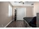 Bright bedroom featuring a double door closet and wood-look floors at 13627 N 150Th Ave, Surprise, AZ 85379