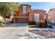 Two-story house with brown exterior, two-car garage, and landscaped front yard at 13627 N 150Th Ave, Surprise, AZ 85379