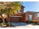 Two-story house with brown exterior, two-car garage, and landscaped front yard at 13627 N 150Th Ave, Surprise, AZ 85379